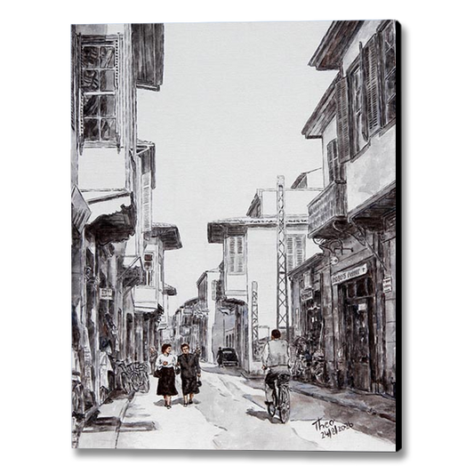 A black and white painting printed on canvas depicting Ledra street around the 1950s, featuring traditional buildings, pedestrians and a cyclist.
