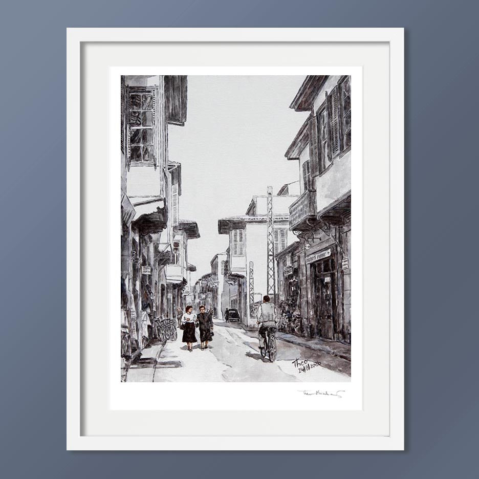 A black and white hand signed fine art print by Theo Michael, depicting Ledra street around the 1950s, featuring traditional buildings, pedestrians and a cyclist.