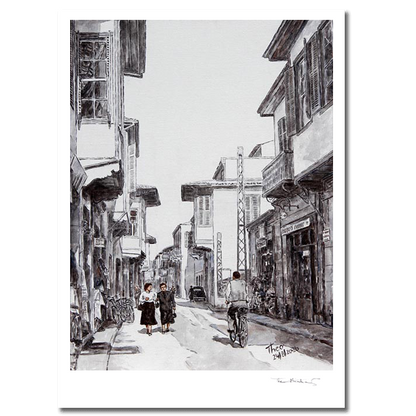 A black and white hand signed fine art print by Theo Michael, depicting Ledra street around the 1950s, featuring traditional buildings, pedestrians and a cyclist.